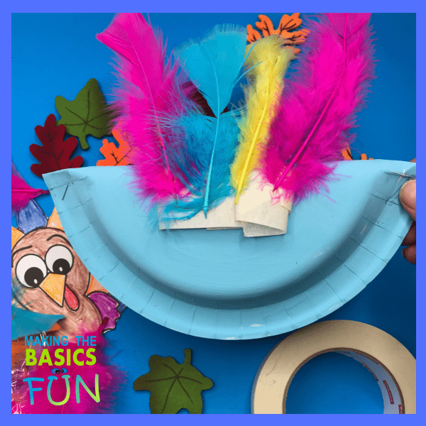 Use tape to attach the feathers to the turkey craft