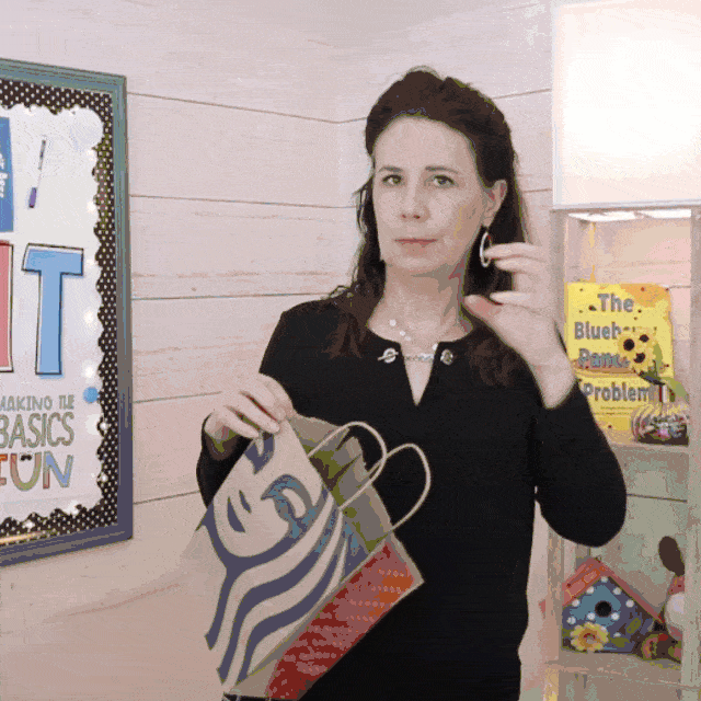 Gif of teacher throwing an invisible ball and catching it with a paper bag