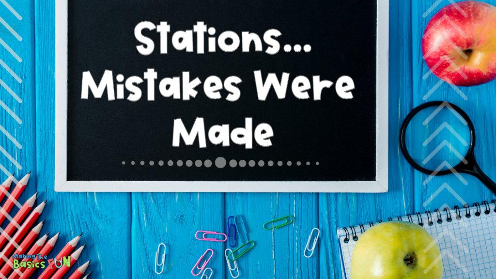 blue wood table with chalkboard saying Stations, Mistakes Were Made, apple, magnifying glass, pencils, paper, clips