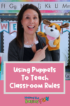 Teacher Angie holding Max the Puppet in an early primary classroom explaining how to use puppets to teach